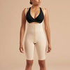 a woman in a bodysuit standing in front of a beige background